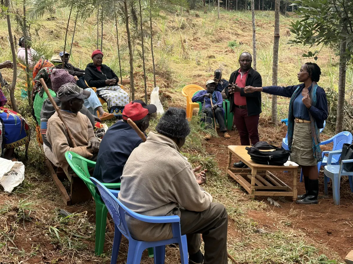 Vivian Nwakah speaking with farmers during an outdoor cooperative field session in Murang'a, Kenya